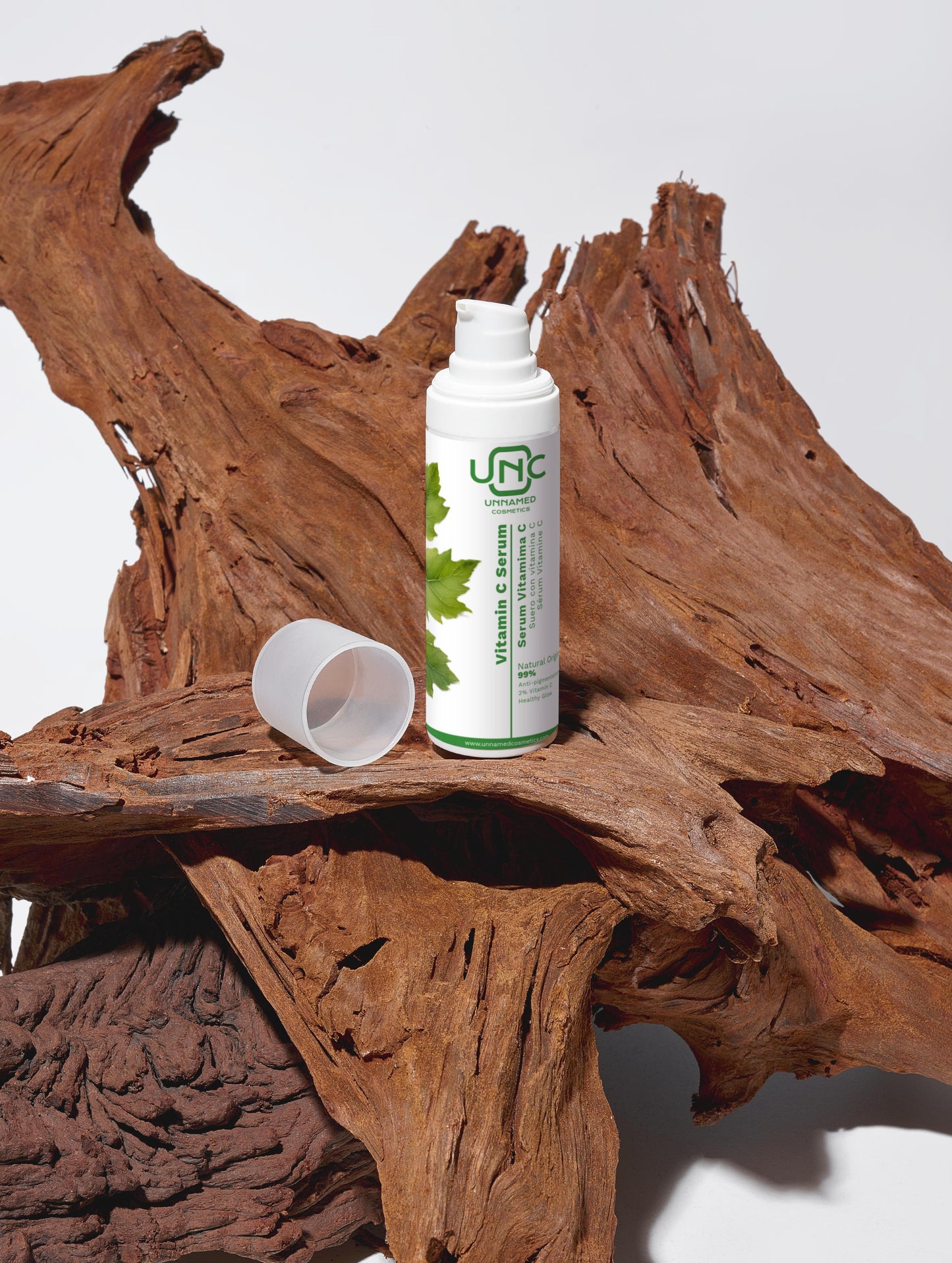 Frasco branco de sérum facial com vitamina C eficaz da Unnamed Cosmetics em fundo de madeira natural